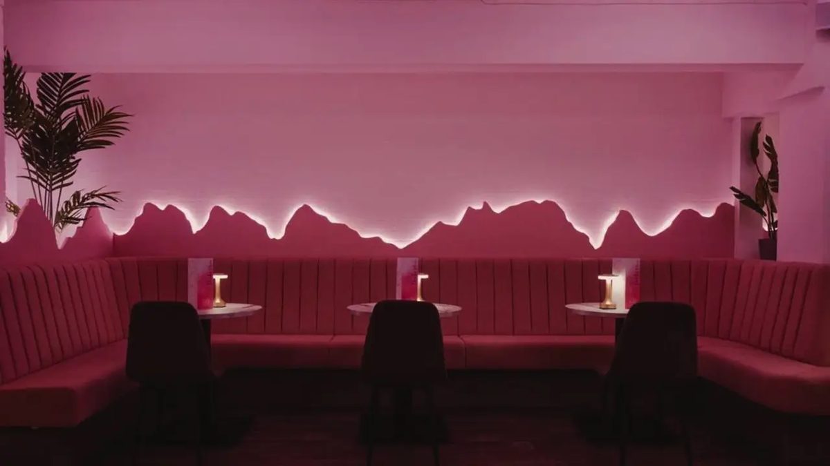 Fluted booths under pink lighting in a restaurant